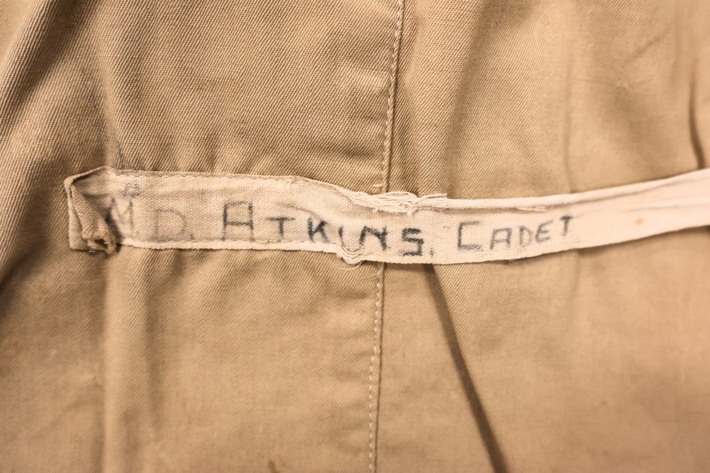 Detail of Maurice Dudley Atkins' 1942 life jacket, showing the name tape with "M.D. Atkins, Cadet" written on it.